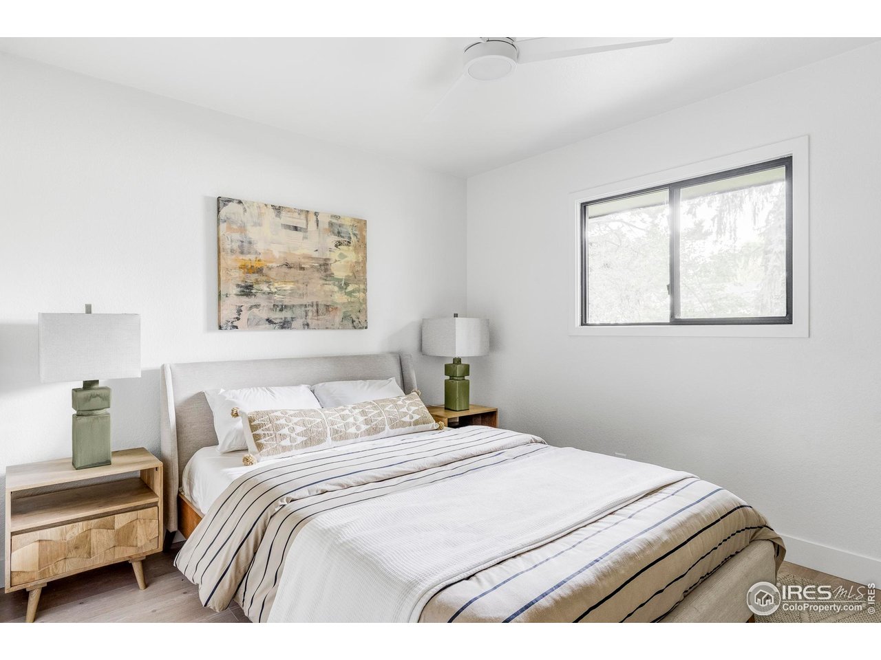 1112 Robertson Street Fort Collins, CO 80524 - Photo 25 of 40 a bedroom with a bed and a painting on the wall