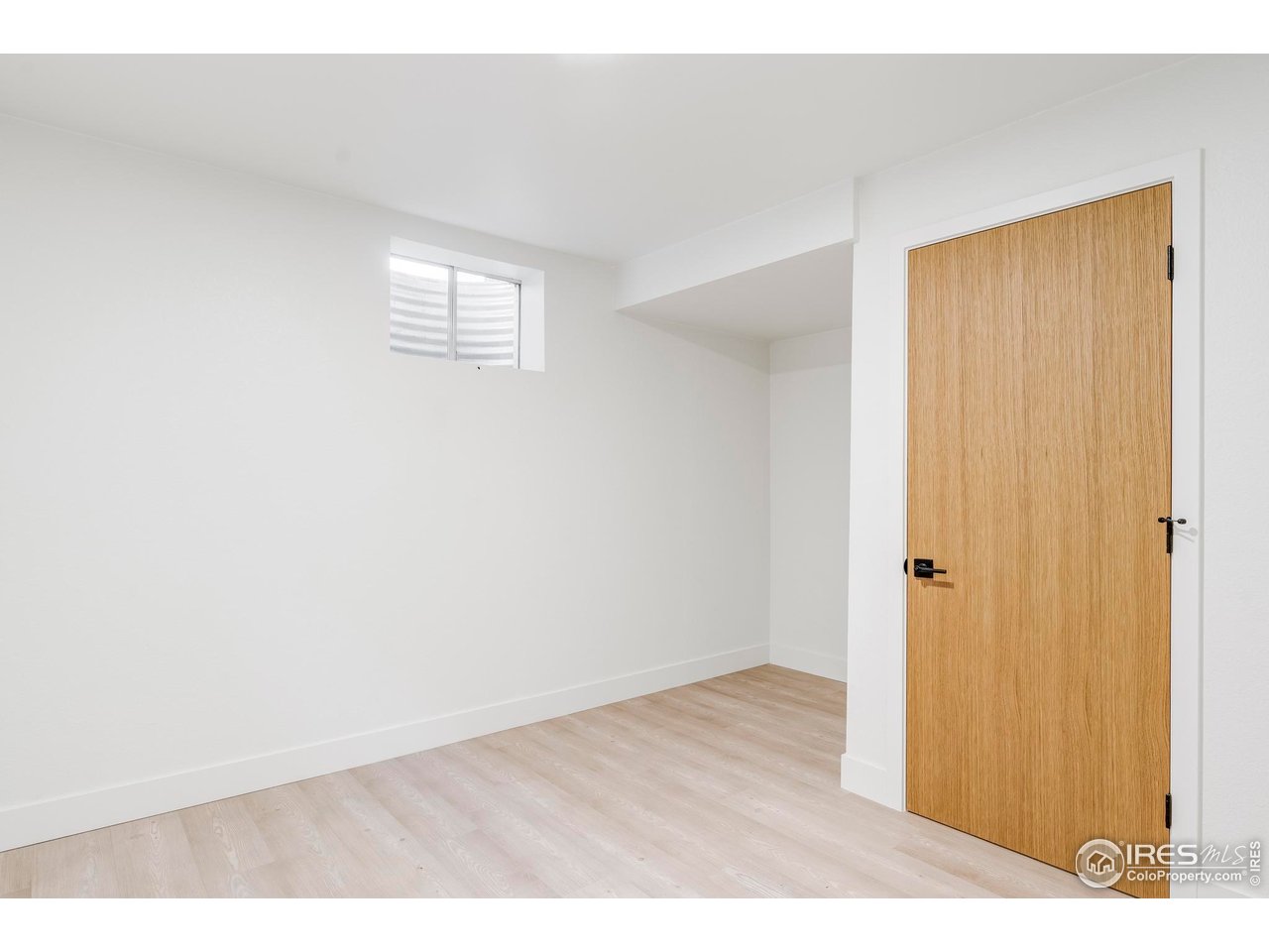 1112 Robertson Street Fort Collins, CO 80524 - Photo 37 of 40 a view of an empty room with wooden floor