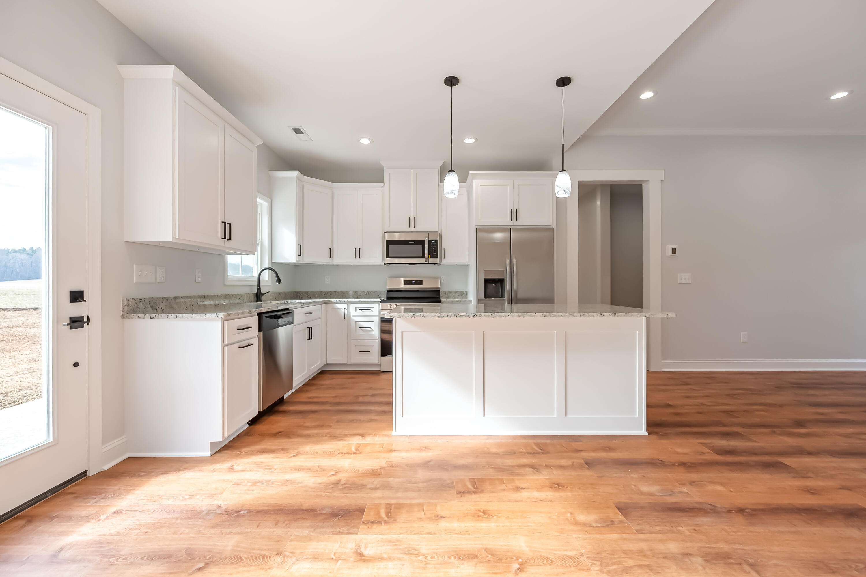 1047 Barberry Road Southeast Floyd, VA 24091 - Photo 13 of 50 a large white kitchen with kitchen island a sink a center island stainless steel appliances and a window