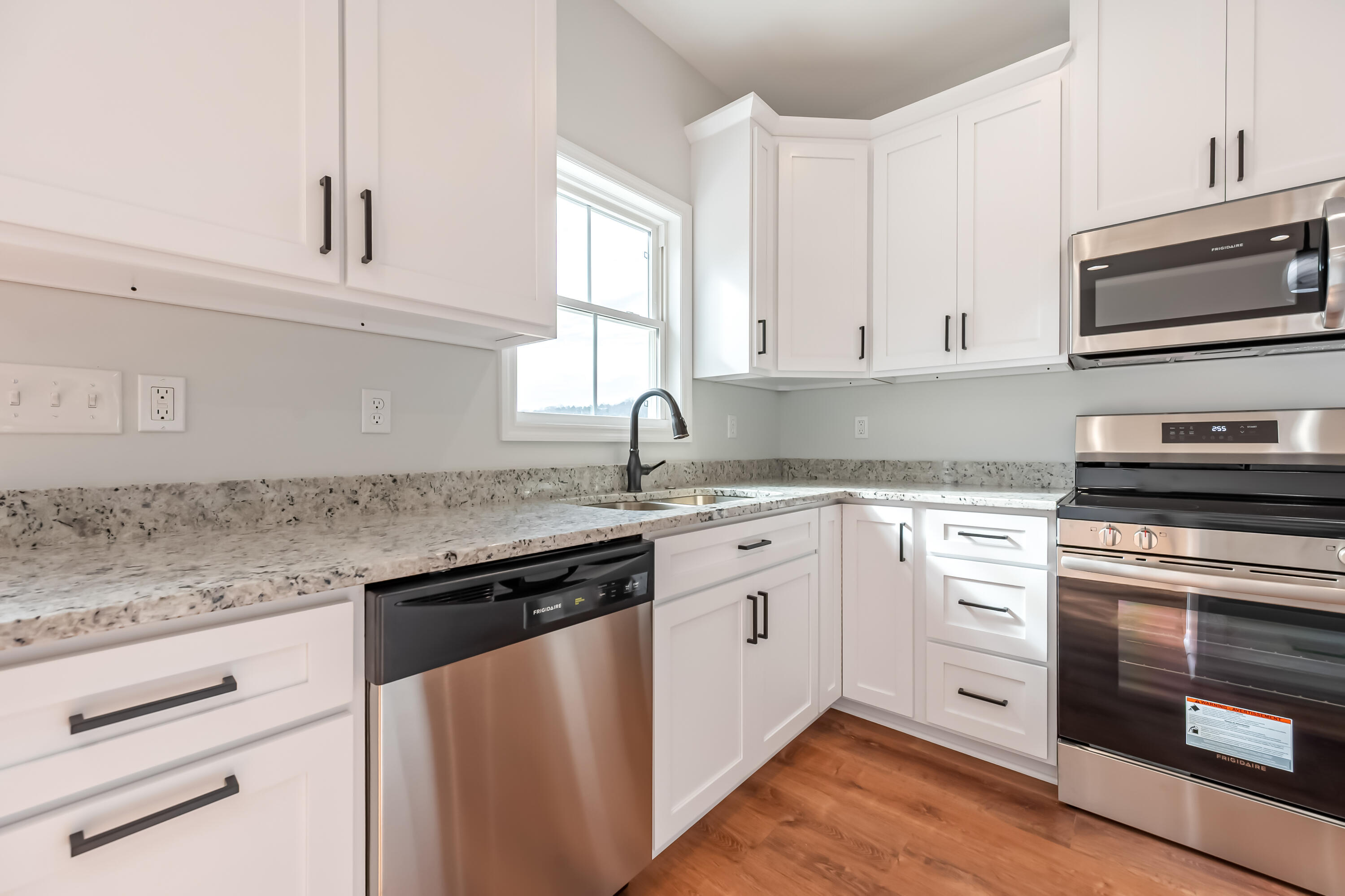 1047 Barberry Road Southeast Floyd, VA 24091 - Photo 16 of 50 a kitchen with granite countertop white cabinets and white appliances