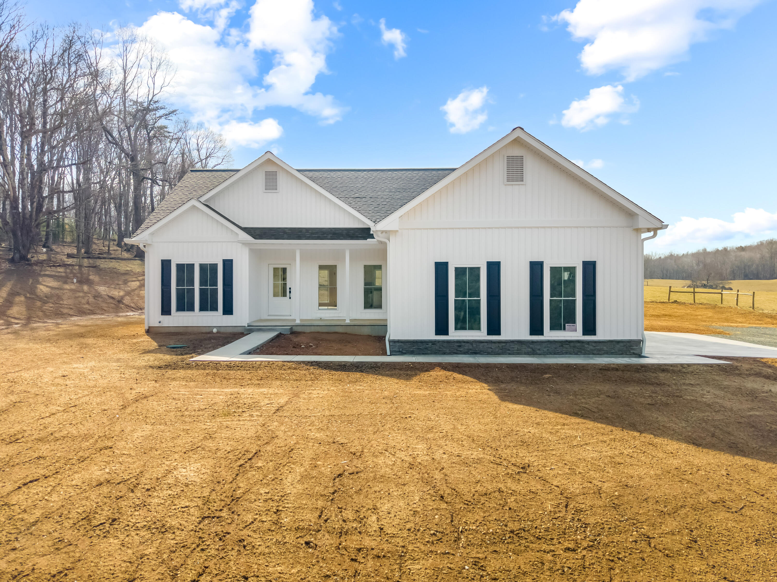 1047 Barberry Road Southeast Floyd, VA 24091 - Photo 2 of 50 a view of a white house with a large windows and palm trees