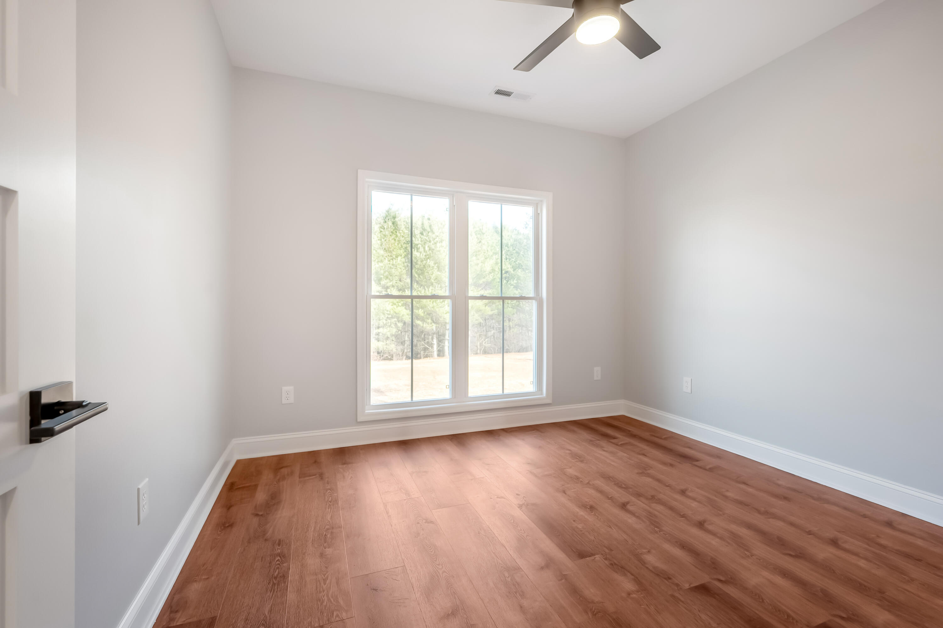 1047 Barberry Road Southeast Floyd, VA 24091 - Photo 35 of 50 an empty room with wooden floor fan and windows