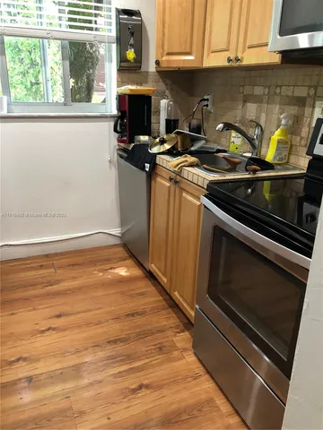 a kitchen with granite countertop a stove and a sink