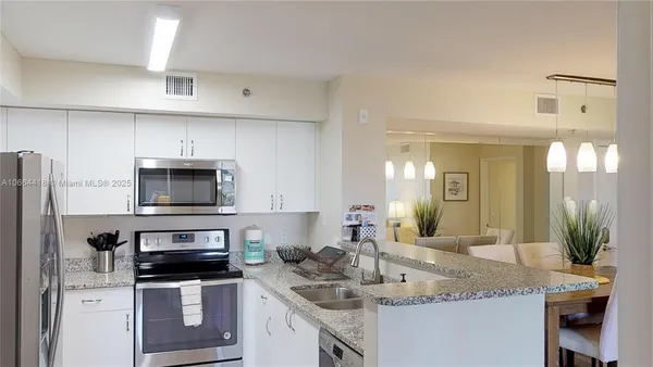 a spacious bedroom with a bed and a dresser in it