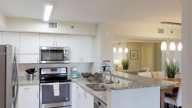 a spacious bedroom with a bed and a dresser in it