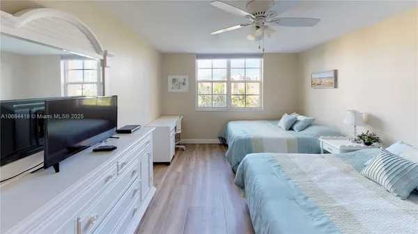 a view of a room with furniture and wooden floor