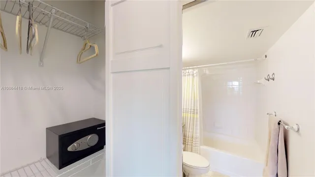 a bathroom with a granite countertop bathtub shower and sink