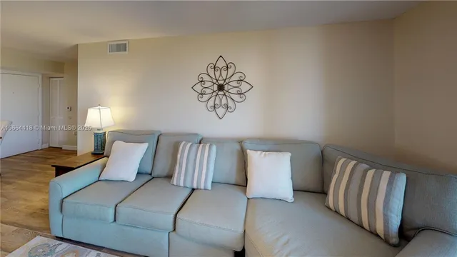 a view of living room with granite countertop furniture and wooden floor