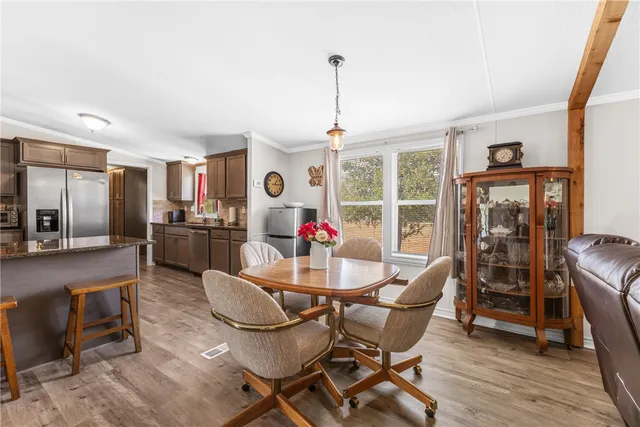 a dining room with furniture a chandelier and wooden floor