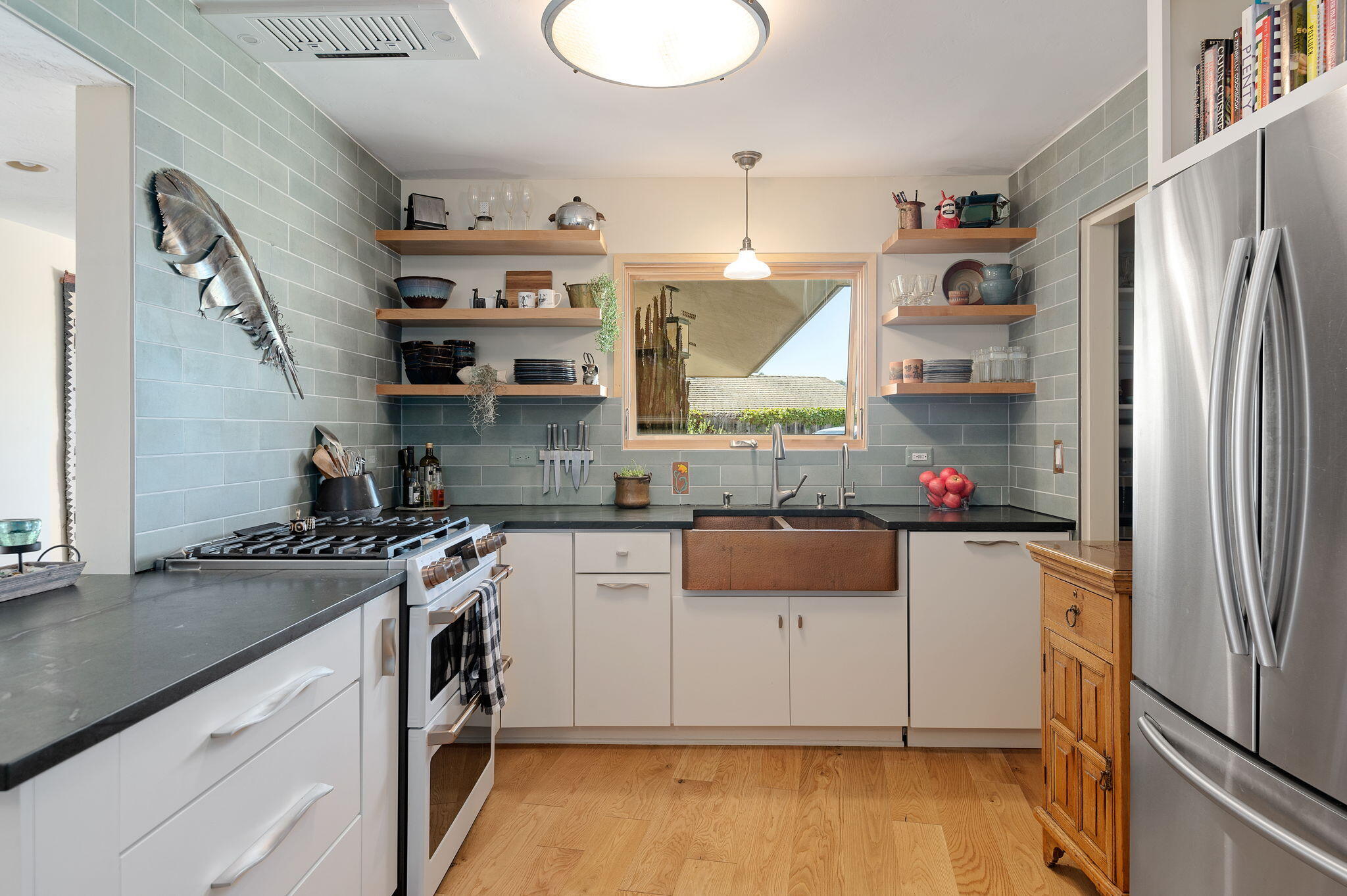 Undisclosed Address Santa Barbara, CA 93109 - Photo 13 of 30 a kitchen with stainless steel appliances granite countertop a refrigerator a stove and a sink with wooden floor