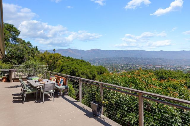 a view of a chairs and table in the balcony