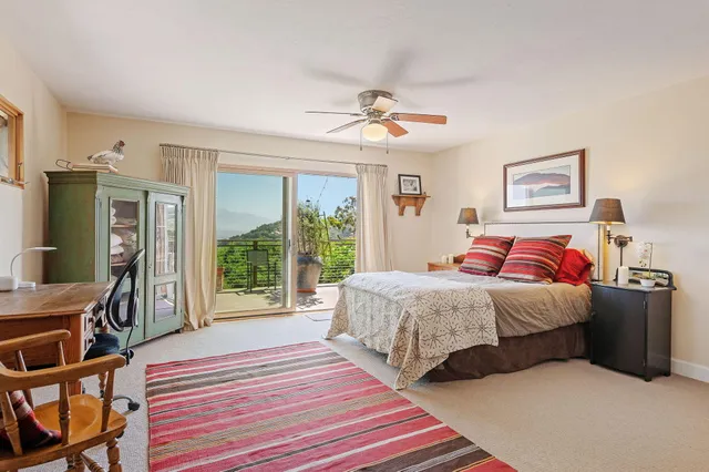 a bedroom with a bed and a large window