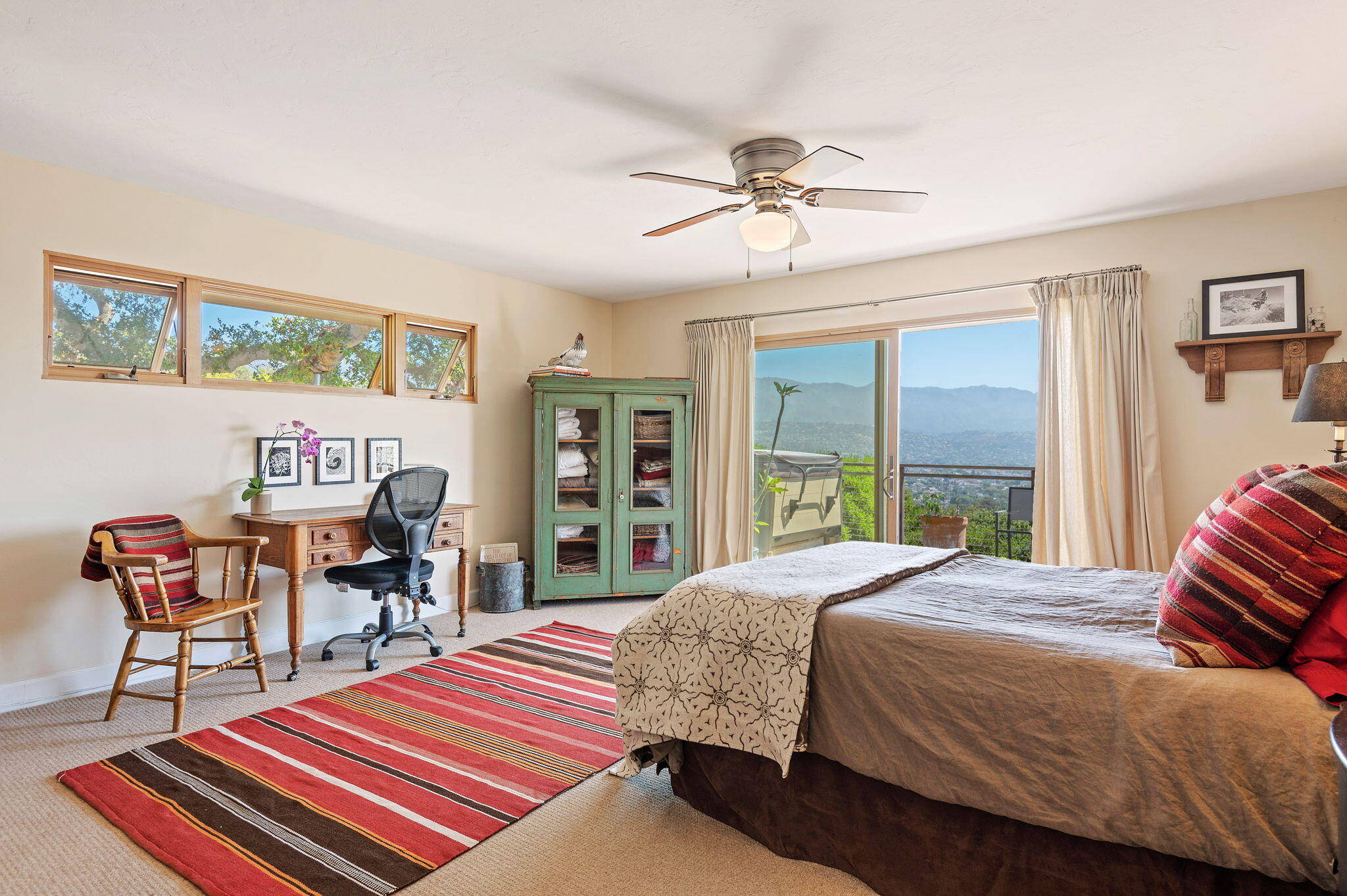 Undisclosed Address Santa Barbara, CA 93109 - Photo 21 of 30 a bedroom with a bed and a chandelier