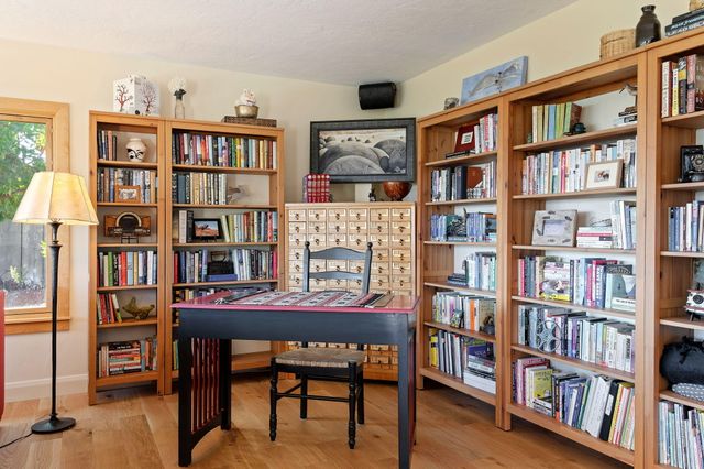 a reading room with furniture and a book shelf