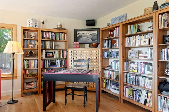 a reading room with furniture and a book shelf