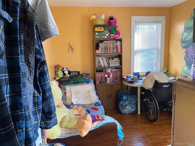a living room with furniture and a book shelf