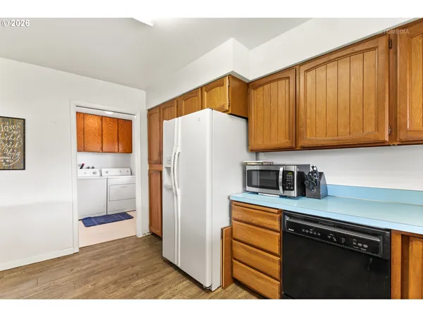 a kitchen with stainless steel appliances granite countertop a refrigerator sink and cabinets