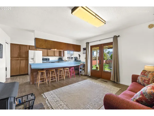 a living room with furniture and a dining table
