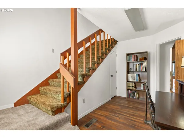 a view of entryway and hall with wooden floor