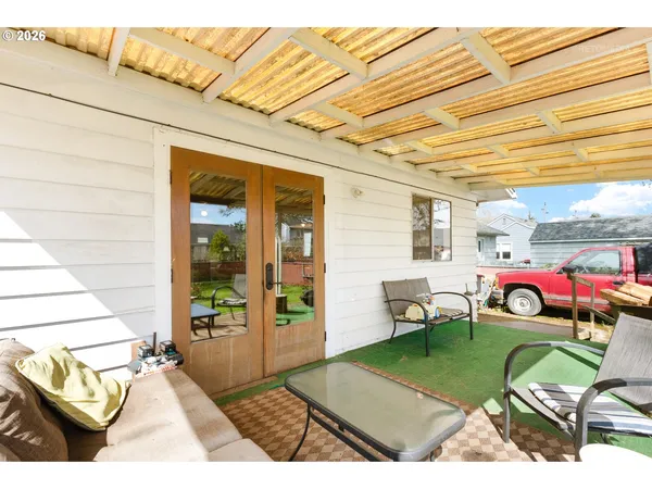 a view of a backyard with furniture and patio