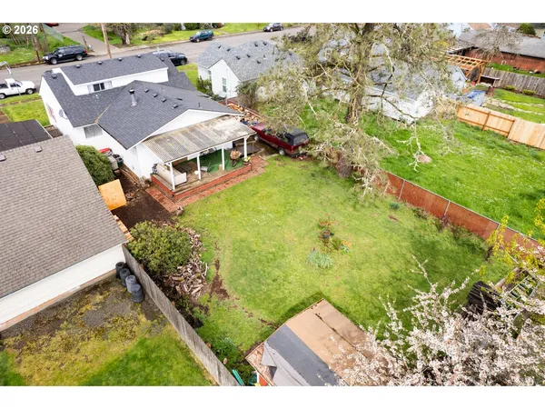an aerial view of residential houses with outdoor space and swimming pool