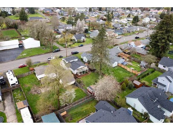 an aerial view of a residential houses with outdoor space