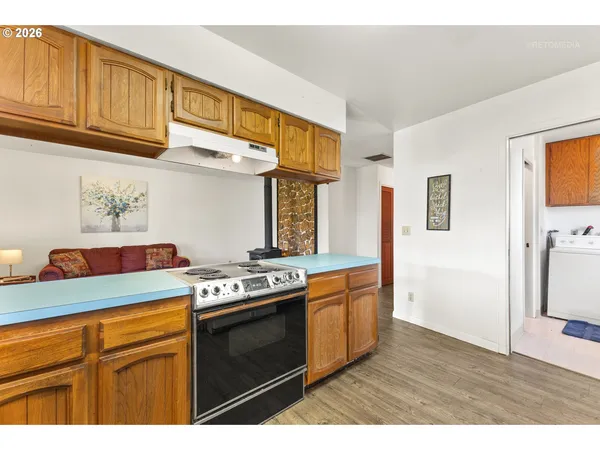 a kitchen with stainless steel appliances granite countertop a stove and a microwave