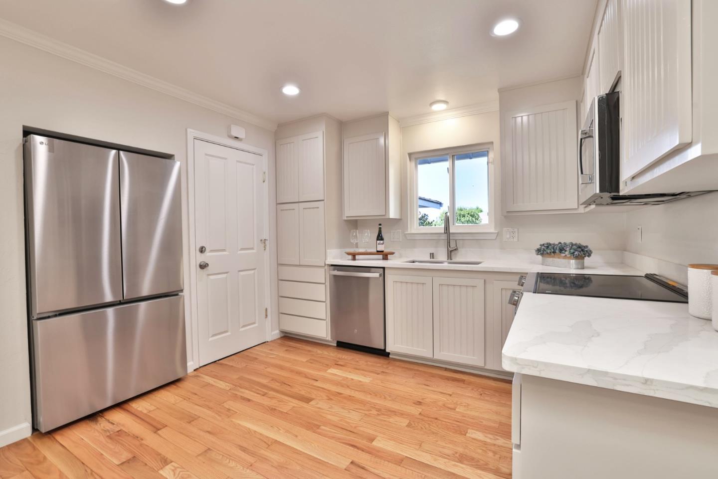 889 Ebbetts Drive Campbell, CA 95008 - Photo 12 of 33 a kitchen with a refrigerator a sink and cabinets