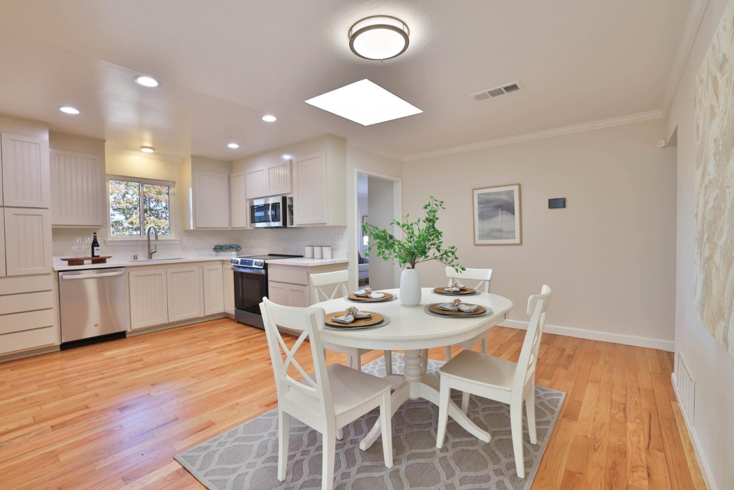 889 Ebbetts Drive Campbell, CA 95008 - Photo 3 of 33 a kitchen with a dining table chairs and white cabinets