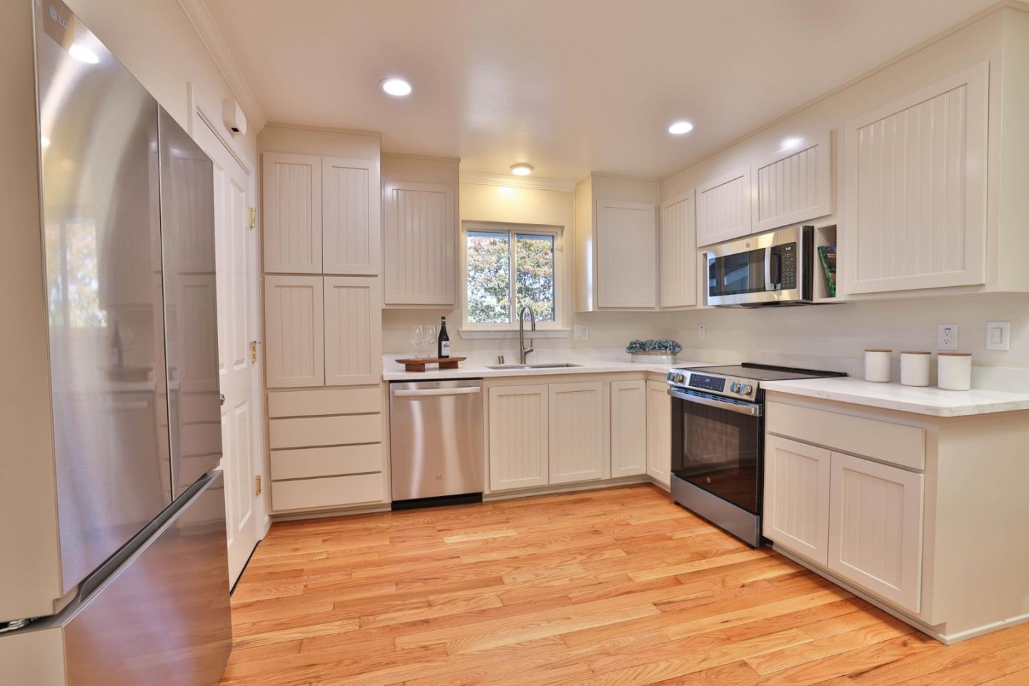 889 Ebbetts Drive Campbell, CA 95008 - Photo 10 of 33 a kitchen with white cabinets and stainless steel appliances