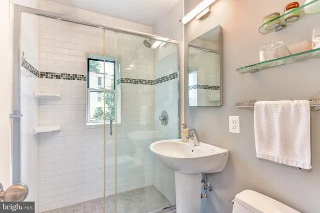 a kitchen with stainless steel appliances granite countertop a sink a stove and a wooden cabinets