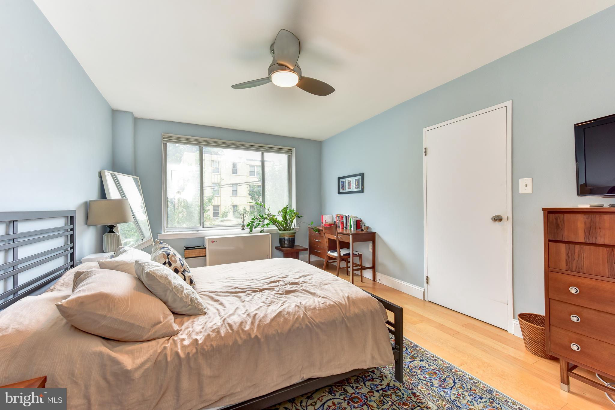 4100 W Street Northwest, Unit 510 Washington, DC 20007 - Photo 12 of 22 a bedroom with a bed and a chandelier