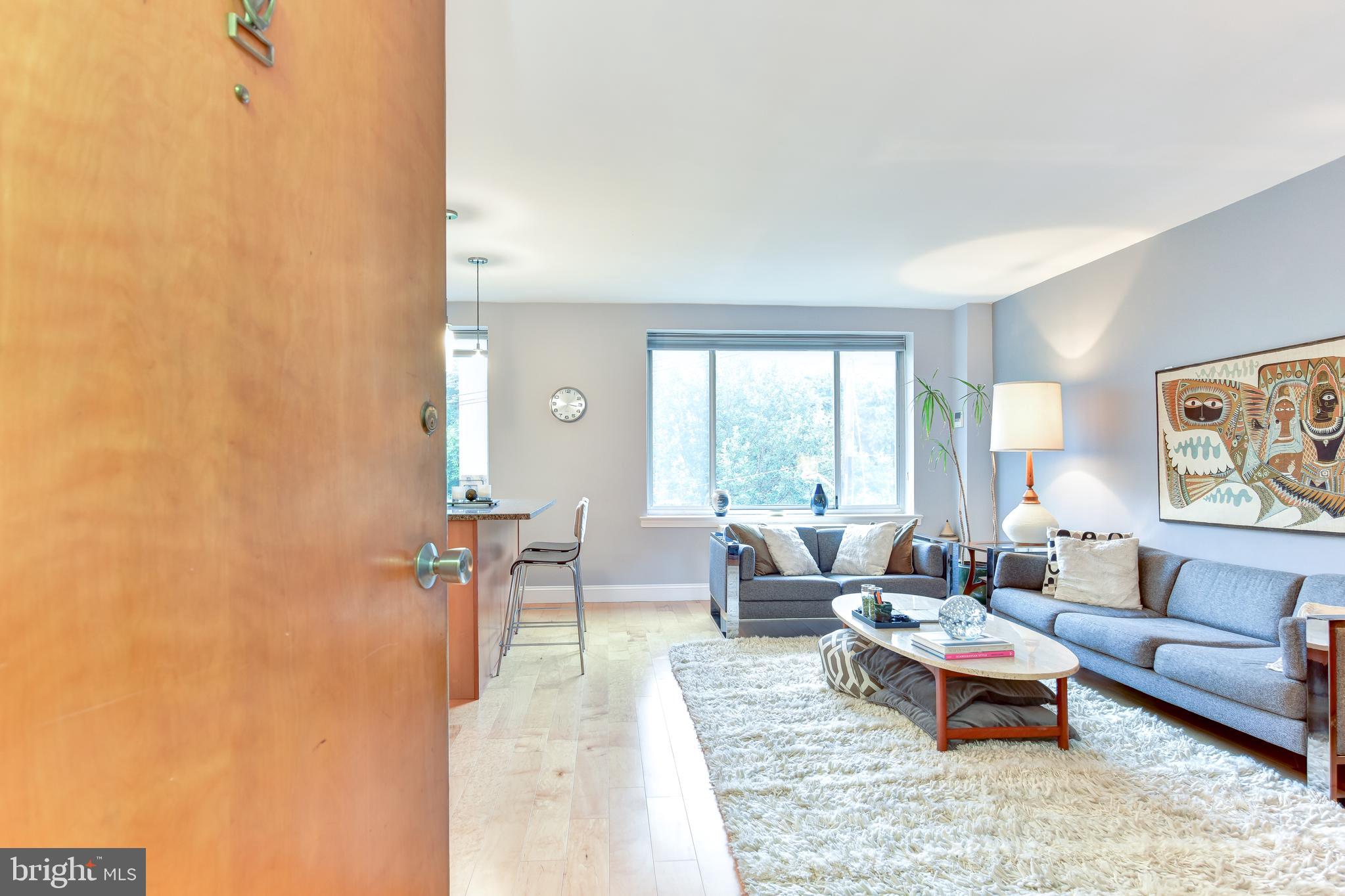 4100 W Street Northwest, Unit 510 Washington, DC 20007 - Photo 2 of 22 a living room with furniture and a large window