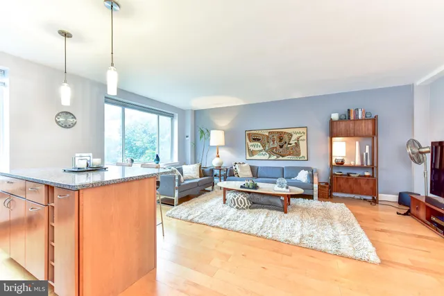 a living room with furniture a window and a chandelier