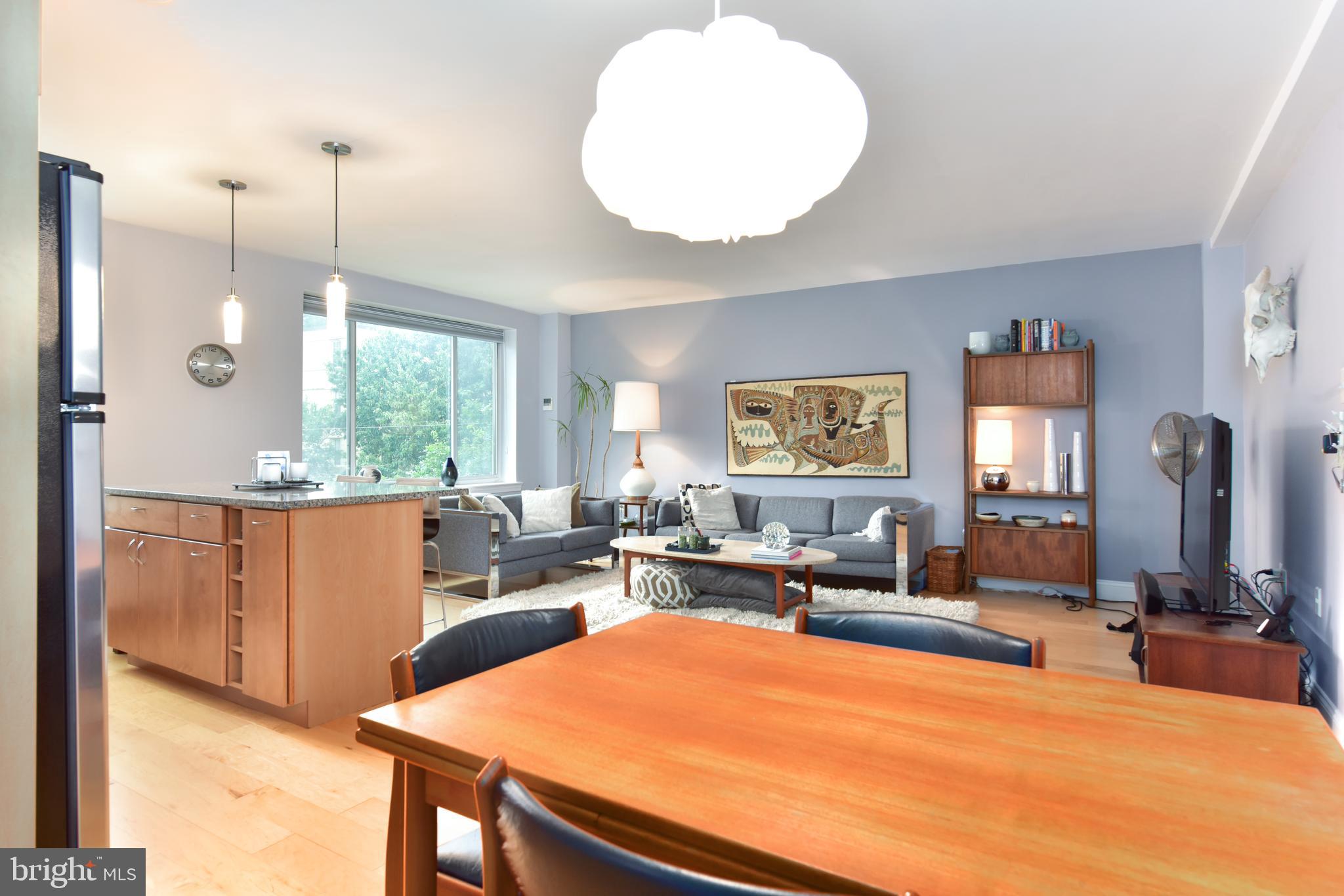 4100 W Street Northwest, Unit 510 Washington, DC 20007 - Photo 22 of 22 a living room with furniture a large window and gym equipment