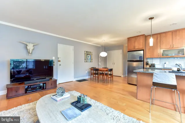 a dining room with furniture and wooden floor