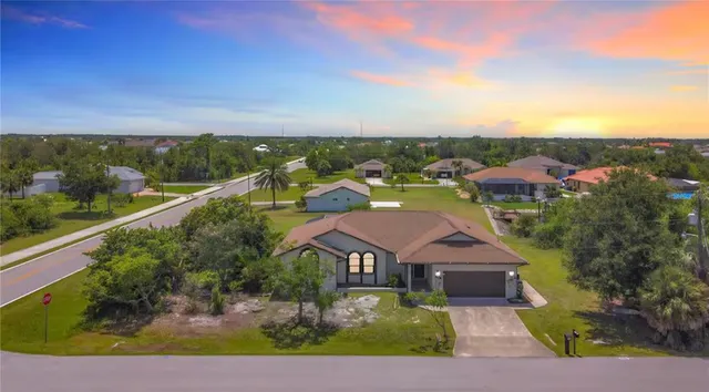 an aerial view of residential houses with outdoor space and street view