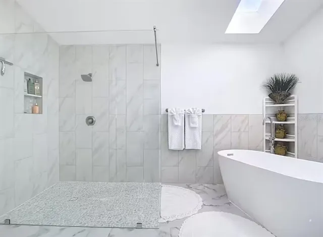 a bathroom with a bathtub and shower