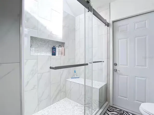 a bathroom with a shower and a sink