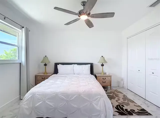 a bedroom with a bed and a window