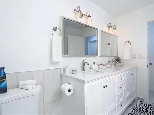 a bathroom with a sink vanity and a mirror