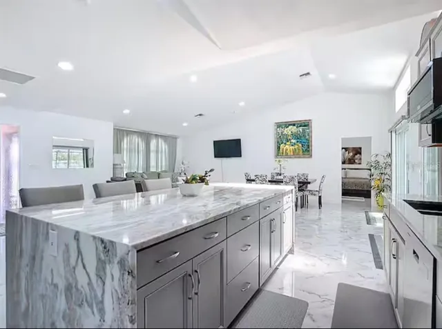 a kitchen with a stove a counter space and a sink