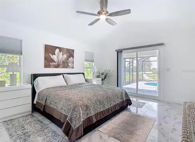 a bedroom with a large bed and a window