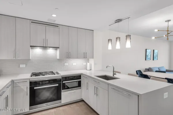 a kitchen with stainless steel appliances a sink stove and cabinets