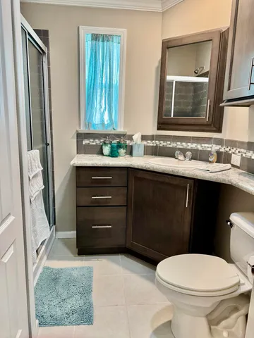 a kitchen with a refrigerator sink and wooden floor