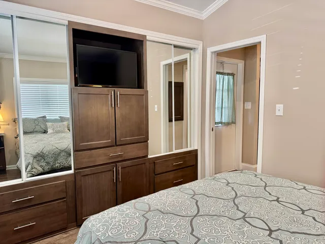 a living room with furniture floor to ceiling window wooden floor and a table