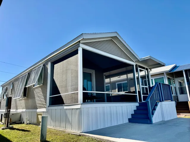 a view of a house with wooden fence
