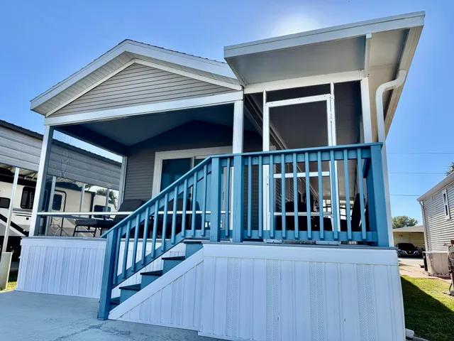 a view of a house with wooden deck and furniture
