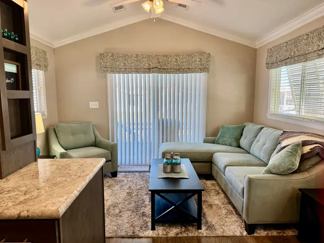 a living room with furniture a dining table and chairs with kitchen view