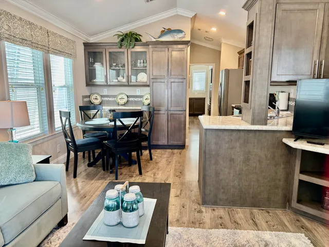 a living room with furniture a large window and a clock